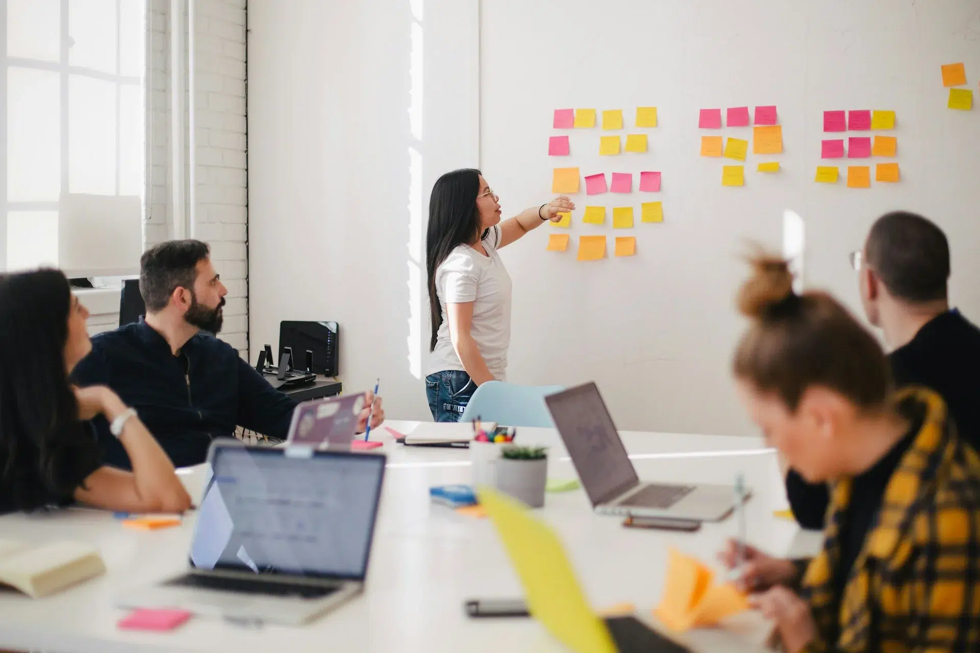 Woman Placing Sticky Notes On Wall